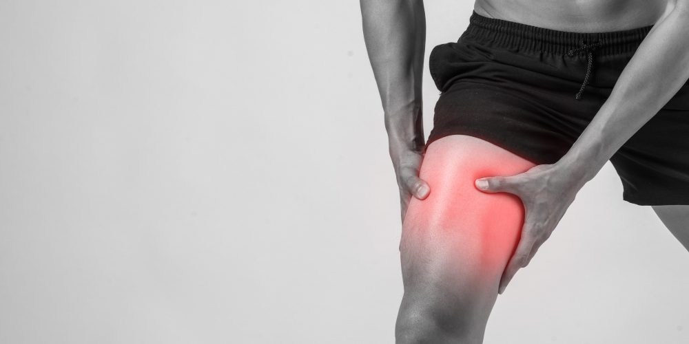 young-sport-man-with-strong-athletic-legs-holding-knee-with-his-hands-pain-after-suffering-ligament-injury-isolated-white