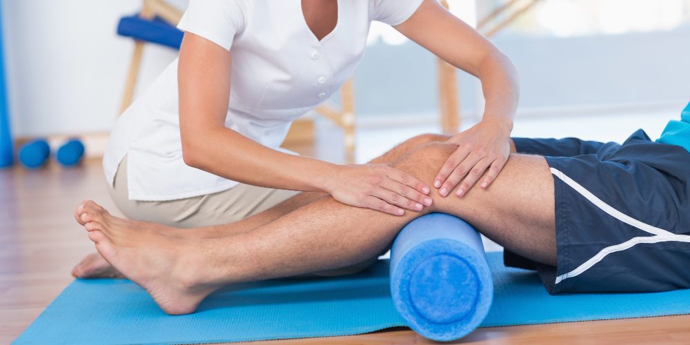 trainer-working-with-man-exercise-mat