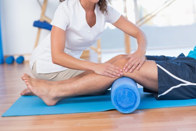 trainer-working-with-man-exercise-mat