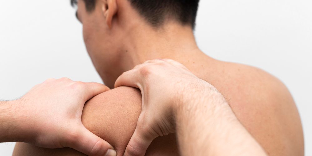 man-getting-shoulder-massage-pain-from-physiotherapist