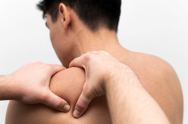 man-getting-shoulder-massage-pain-from-physiotherapist