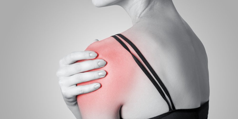 young-woman-with-pain-her-arm-shoulder-gray-background